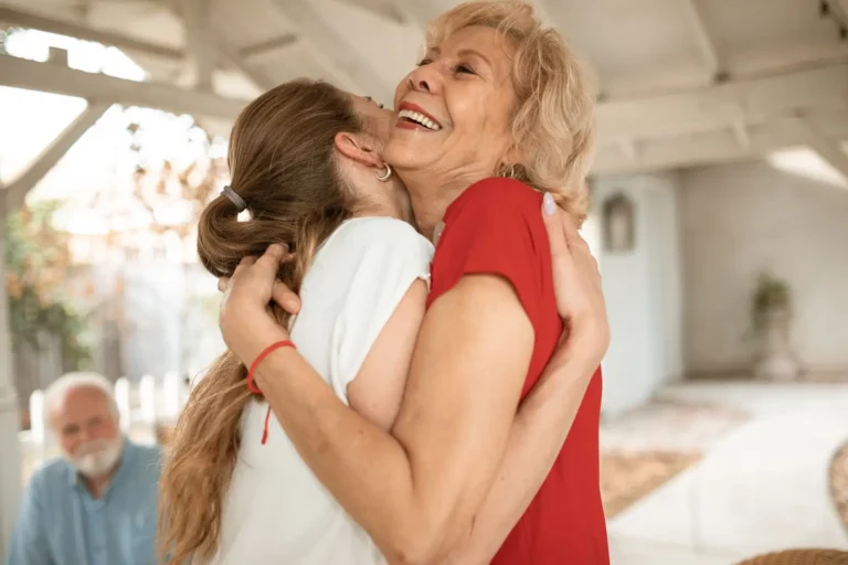 Visiting relatives greeting each other with a hug