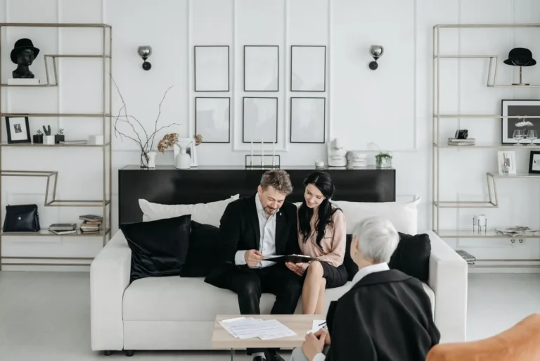 Couple reading papers on a sofa during a visit at home