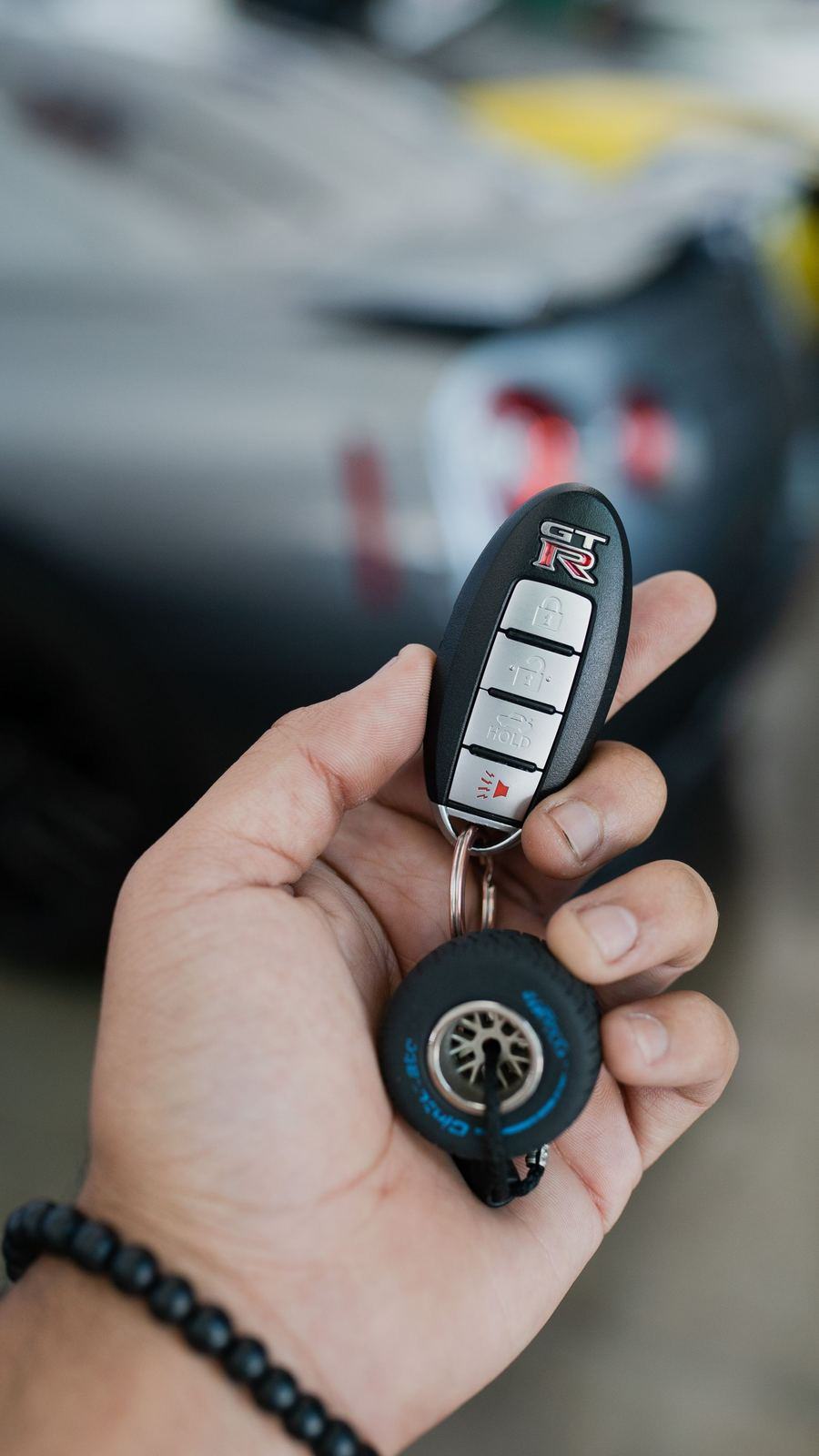 Hand holding a car key fob