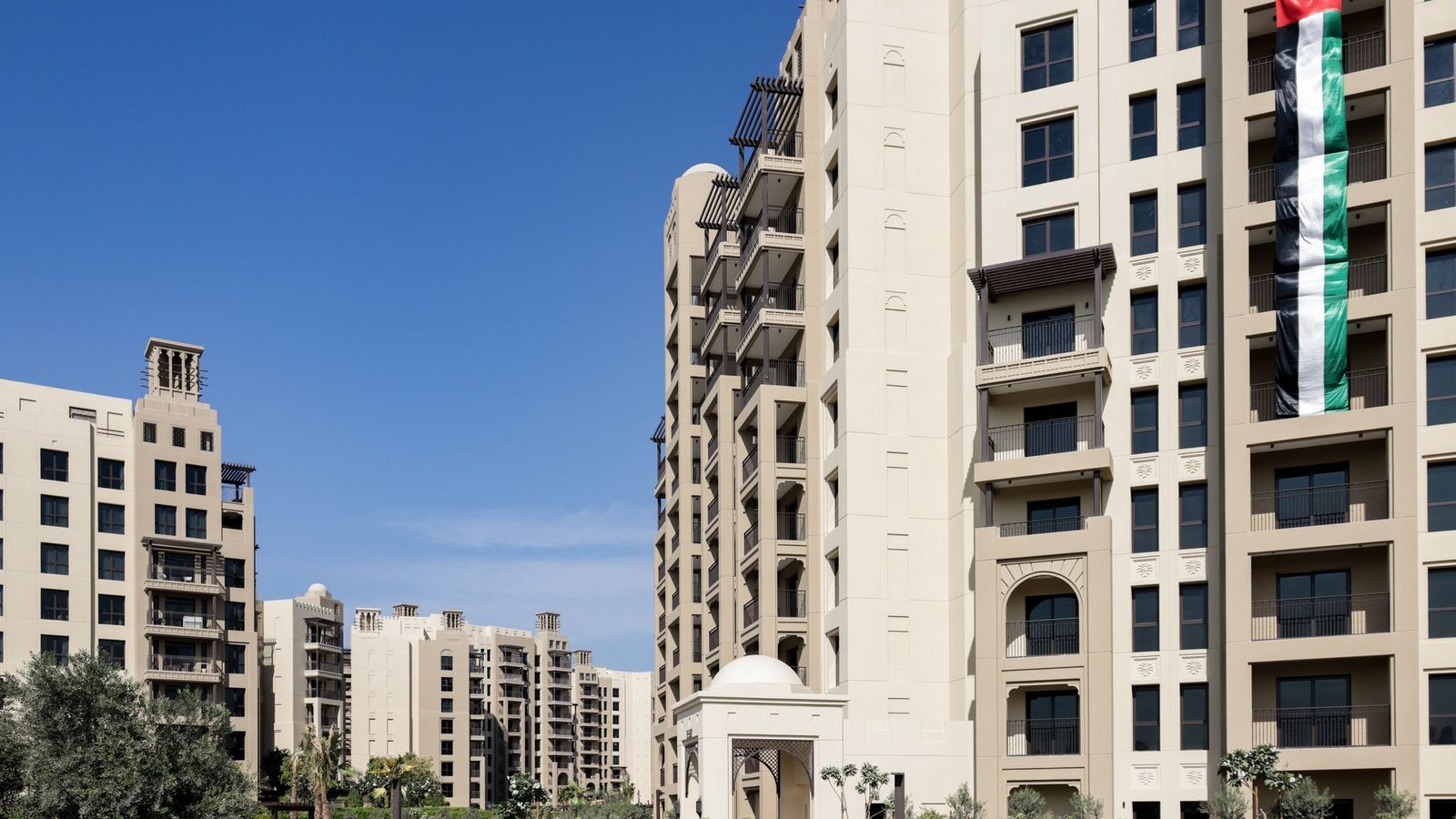 Residential apartment buildings in Dubai under a blue sky, home address for proof of address in UAE