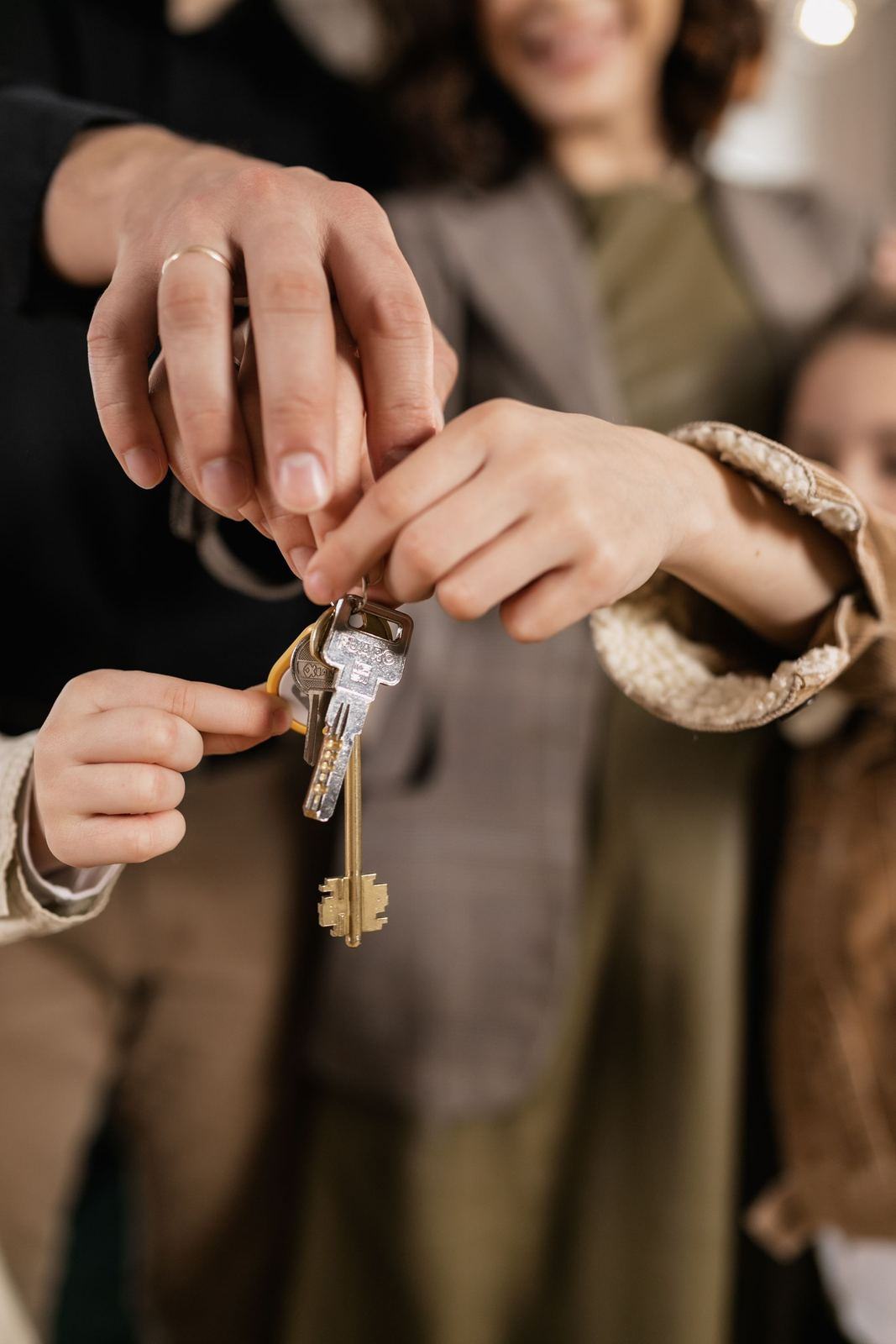 Hands passing a set of keys from one person to another