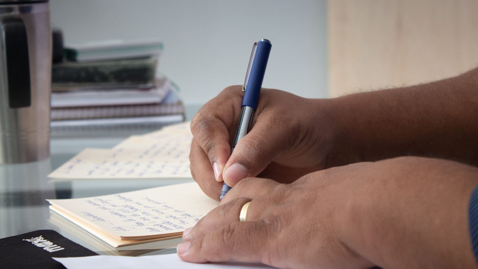 Man's hands signing a letter at a desk, the meaning of a consent letter in practice